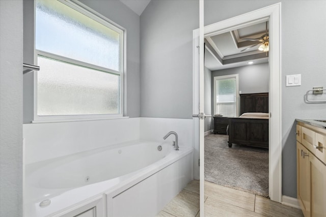 2231 Rana Park, Flint, TX 75762 - bathroom with a jetted tub, ensuite bath, vanity, a ceiling fan, and baseboards