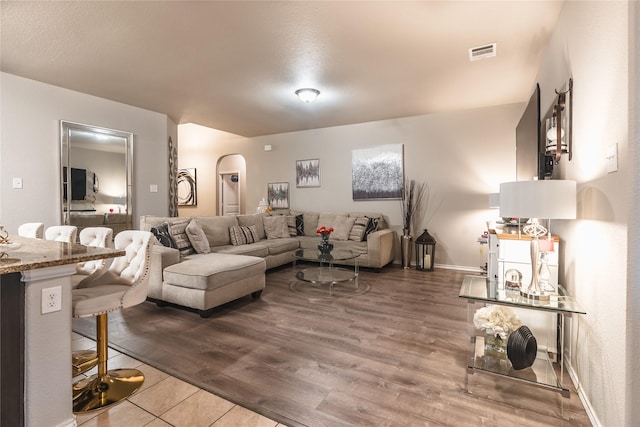 2717 Swift Creek Dr, Fort Worth, TX 76123 - living area featuring arched walkways, wood finished floors, and baseboards