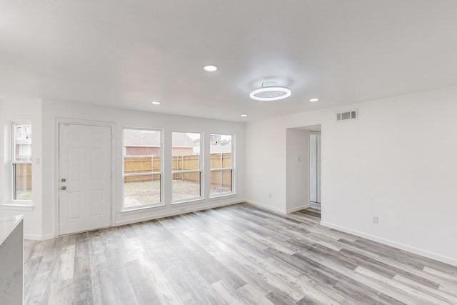 827 Astaire Ave, Duncanville, TX 75137 - unfurnished living room with light wood finished floors, baseboards, and recessed lighting
