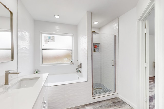 827 Astaire Ave, Duncanville, TX 75137 - full bath with a shower stall, wood finished floors, vanity, a garden tub, and recessed lighting