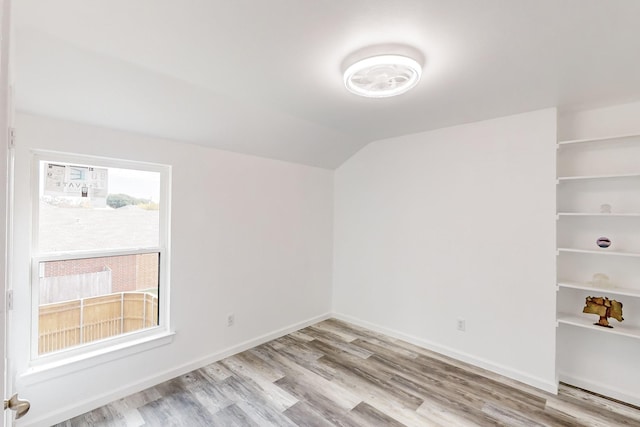 827 Astaire Ave, Duncanville, TX 75137 - unfurnished room featuring wood finished floors, lofted ceiling, and baseboards