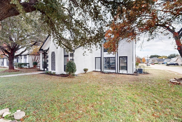 827 Astaire Ave, Duncanville, TX 75137 - back of property with brick siding and a yard