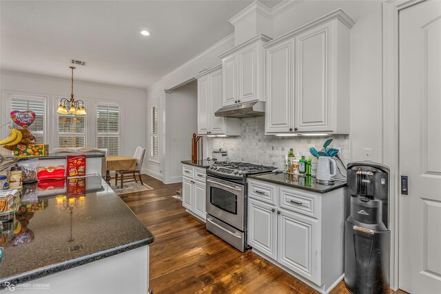 kitchen featuring stainless steel range with gas cooktop, decorative backsplash, under cabinet range hood, dark wood-style flooring, and white cabinets