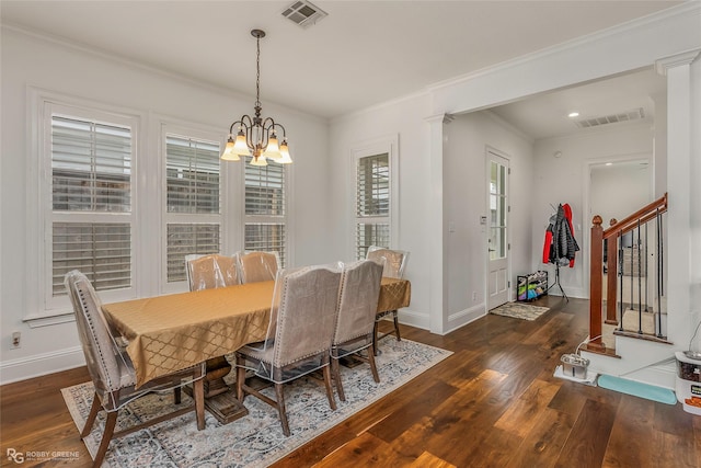 dining space featuring wood finished floors, a chandelier, ornamental molding, baseboards, and stairs
