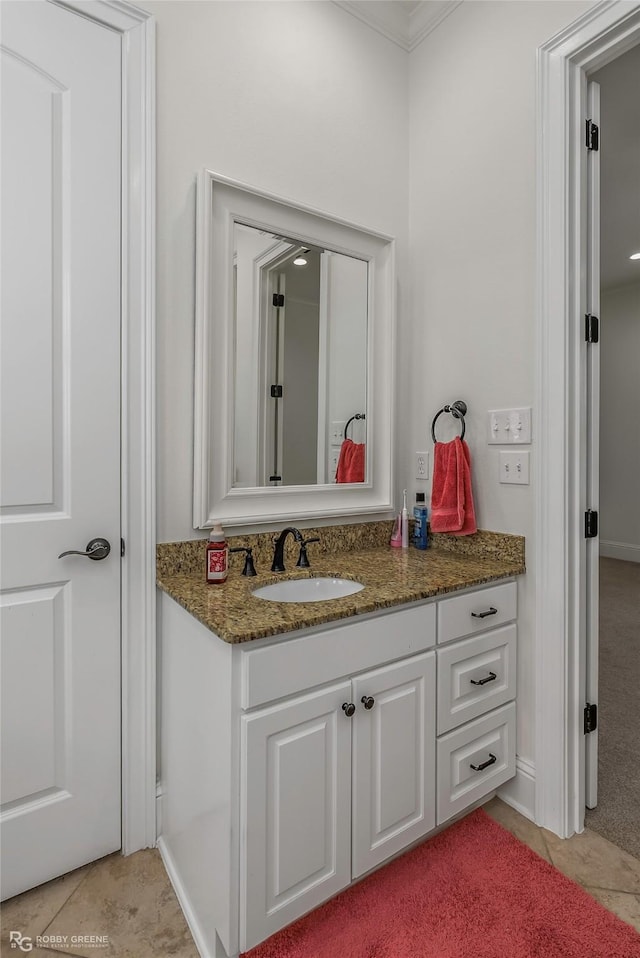 bathroom featuring tile patterned floors, vanity, and ornamental molding