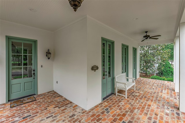 view of exterior entry with stucco siding and a ceiling fan