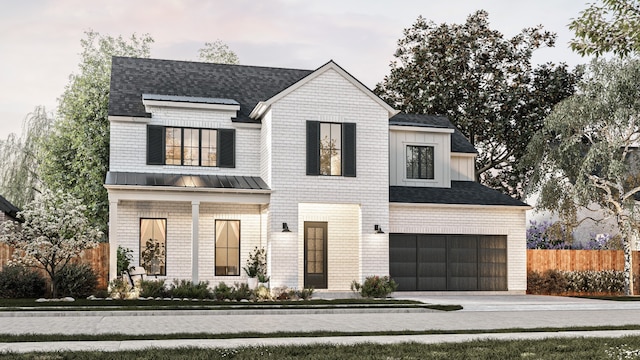 modern farmhouse featuring fence, an attached garage, driveway, and a standing seam roof