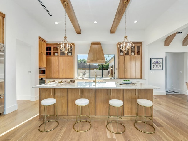 4633 Willow Ln, Dallas, TX 75244 - kitchen with a chandelier, light wood finished floors, a sink, beamed ceiling, and light countertops