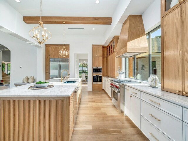 4633 Willow Ln, Dallas, TX 75244 - kitchen featuring premium range hood, high quality appliances, a sink, arched walkways, and beamed ceiling