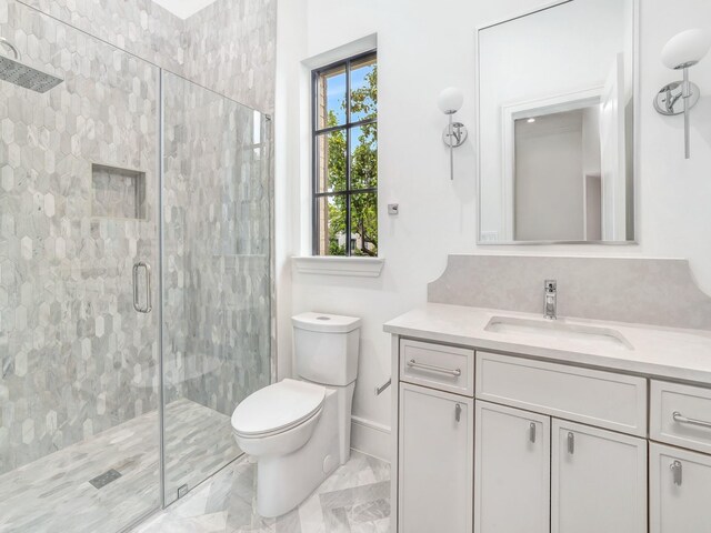 4633 Willow Ln, Dallas, TX 75244 - full bath with vanity, a shower stall, toilet, marble finish floors, and baseboards