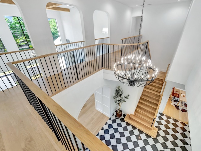 4633 Willow Ln, Dallas, TX 75244 - stairway featuring wood finished floors, a chandelier, recessed lighting, and arched walkways