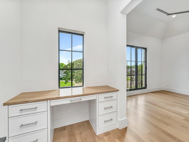4633 Willow Ln, Dallas, TX 75244 - unfurnished office featuring built in study area, light wood-style flooring, and baseboards
