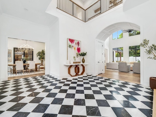 4633 Willow Ln, Dallas, TX 75244 - entrance foyer with a high ceiling, a chandelier, arched walkways, and tile patterned flooring