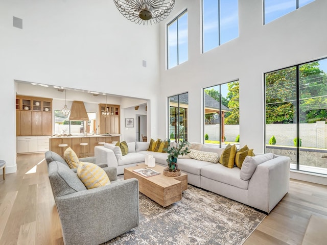 4633 Willow Ln, Dallas, TX 75244 - living area featuring a chandelier, a high ceiling, and light wood finished floors