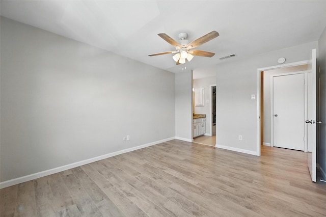 14800 Enterprise Dr Unit 17A, Farmers Branch, TX 75234 - unfurnished bedroom featuring light wood-style flooring, baseboards, connected bathroom, and a ceiling fan