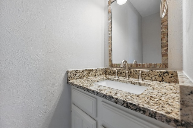 14800 Enterprise Dr Unit 17A, Farmers Branch, TX 75234 - bathroom featuring vanity and a textured wall