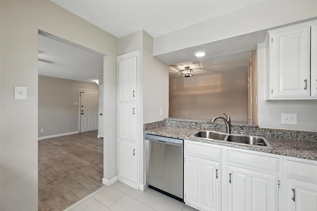 14800 Enterprise Dr Unit 17A, Farmers Branch, TX 75234 - kitchen with stainless steel dishwasher, a sink, white cabinetry, baseboards, and light tile patterned floors