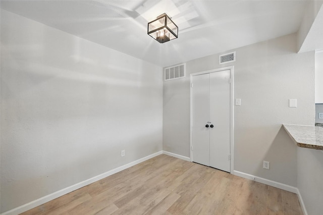 14800 Enterprise Dr Unit 17A, Farmers Branch, TX 75234 - unfurnished bedroom with light wood-style floors, baseboards, and a closet