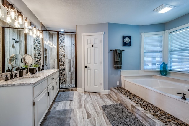 6500 Brenda, Malakoff, TX 75148 - full bathroom with a shower stall, a bath, double vanity, baseboards, and recessed lighting