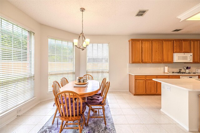 5929 Meadowcrest Ln, Sachse, TX 75048 - dining room featuring a chandelier, light tile patterned flooring, a textured ceiling, and baseboards