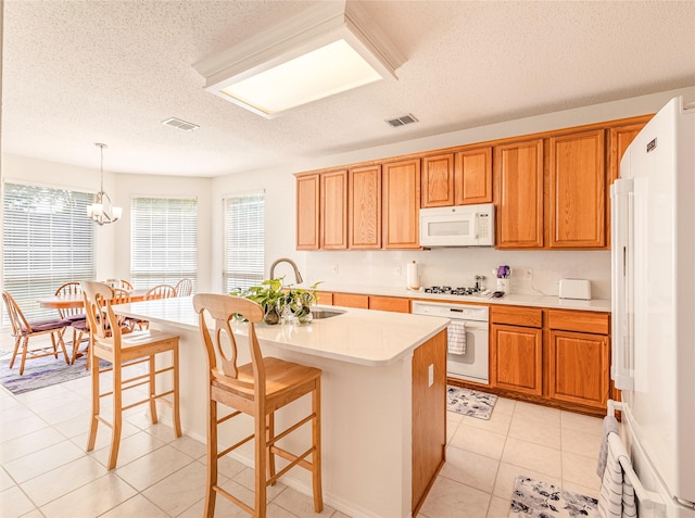 5929 Meadowcrest Ln, Sachse, TX 75048 - kitchen with white appliances, a sink, a textured ceiling, light countertops, and a kitchen island with sink