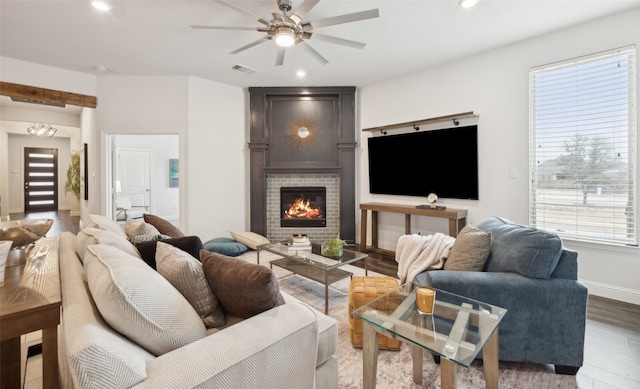 613 Overton Ave, Celina, TX 75009 - living area with a ceiling fan, wood finished floors, a tiled fireplace, baseboards, and recessed lighting