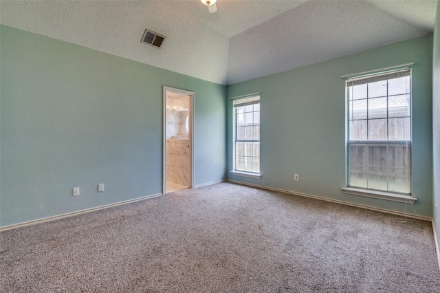 carpeted spare room with baseboards and a textured ceiling