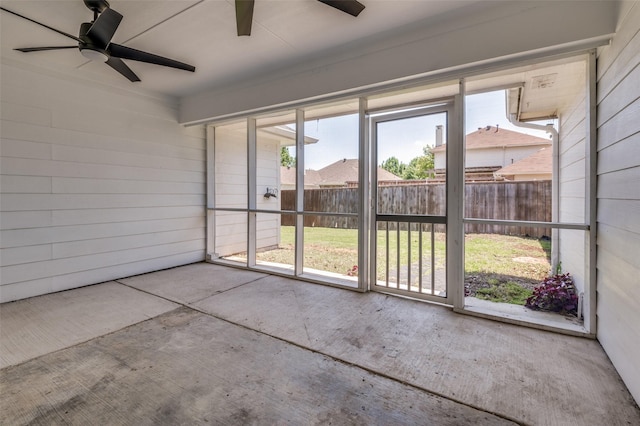 unfurnished sunroom with a ceiling fan