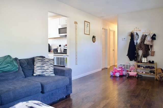 110 S Alma Ave, Kerens, TX 75144 - living area featuring dark wood-style floors and baseboards