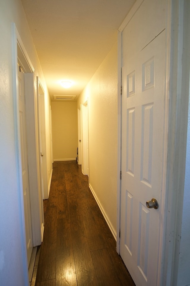 110 S Alma Ave, Kerens, TX 75144 - hall with dark wood-style floors, baseboards, and attic access