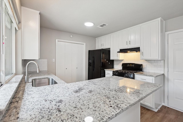 404 Anita Ave, Keller, TX 76248 - kitchen featuring black appliances, a sink, under cabinet range hood, and white cabinetry