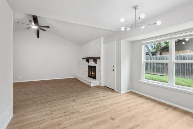 404 Anita Ave, Keller, TX 76248 - unfurnished living room with vaulted ceiling, a chandelier, light wood-style floors, a fireplace, and ceiling fan