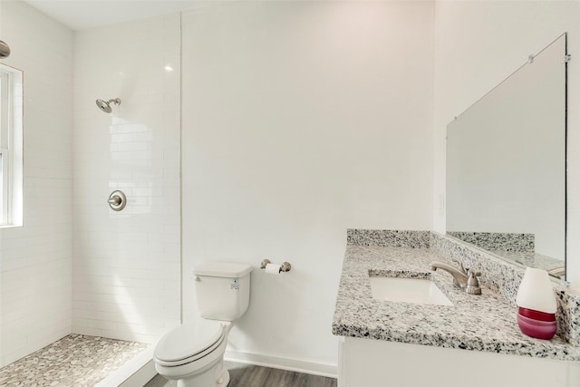 4423 Colonial Ave, Dallas, TX 75215 - full bath featuring toilet, a tile shower, wood finished floors, and vanity