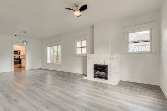 4423 Colonial Ave, Dallas, TX 75215 - unfurnished living room featuring ceiling fan, light wood finished floors, a fireplace, and baseboards
