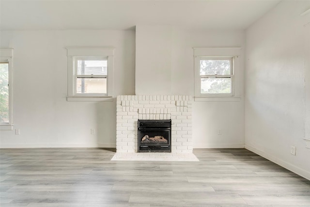 4423 Colonial Ave, Dallas, TX 75215 - unfurnished living room featuring healthy amount of natural light, wood finished floors, a fireplace, and baseboards