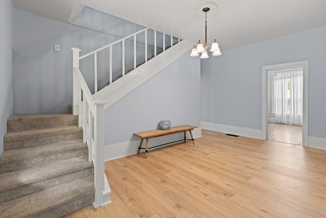 229 College, Italy, TX 76651 - staircase with wood finished floors, a chandelier, and baseboards