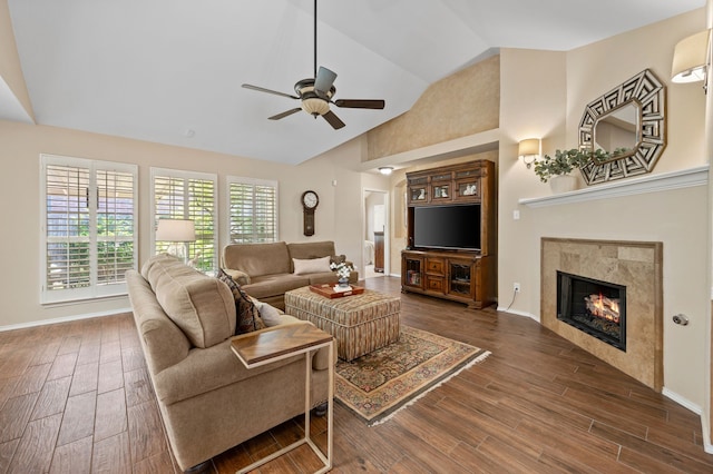 4252 Millview Ln, Dallas, TX 75287 - living area featuring a ceiling fan, wood finished floors, a tiled fireplace, high vaulted ceiling, and baseboards