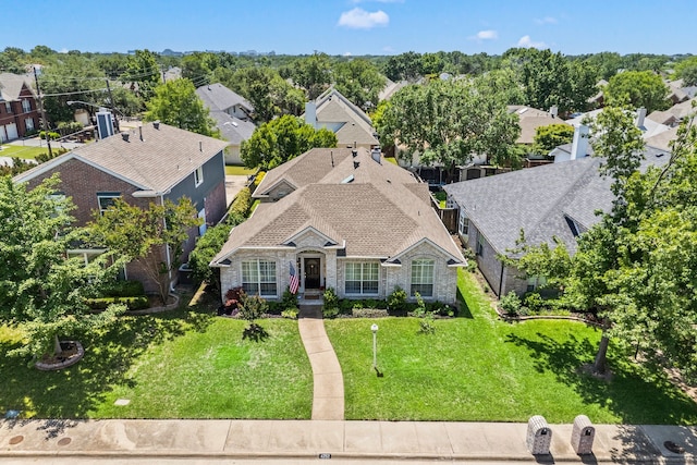 4252 Millview Ln, Dallas, TX 75287 - view of front of house with stone siding, a residential view, a front lawn, and roof with shingles