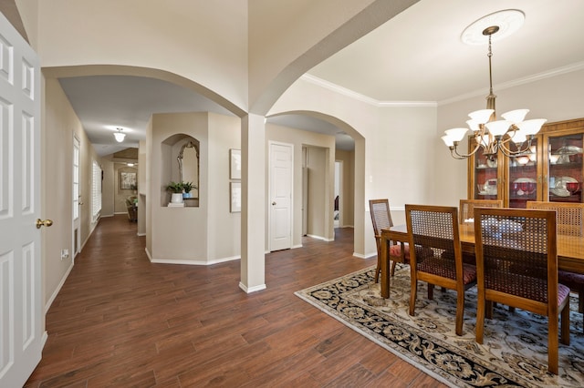 4252 Millview Ln, Dallas, TX 75287 - dining space with arched walkways, a chandelier, baseboards, dark wood finished floors, and crown molding