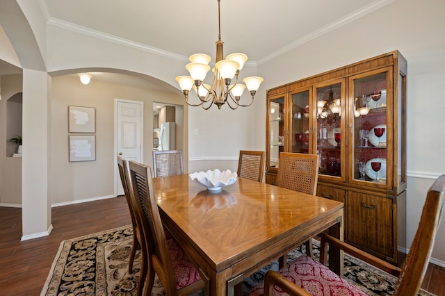 4252 Millview Ln, Dallas, TX 75287 - dining area with arched walkways, dark wood-style flooring, a chandelier, ornamental molding, and baseboards