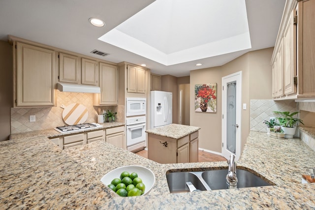 4252 Millview Ln, Dallas, TX 75287 - kitchen with white appliances, a sink, under cabinet range hood, decorative backsplash, and light stone countertops