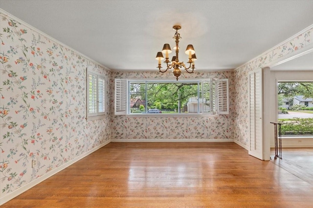 2900 Simondale Dr, Fort Worth, TX 76109 - unfurnished dining area with wallpapered walls, a chandelier, wood finished floors, healthy amount of natural light, and baseboards
