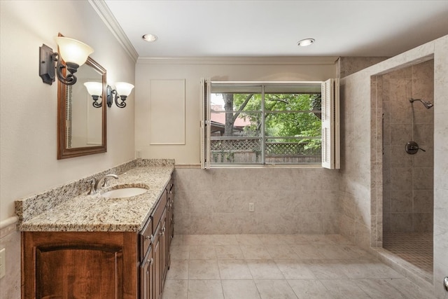2900 Simondale Dr, Fort Worth, TX 76109 - bathroom featuring vanity, a tile shower, tile patterned floors, tile walls, and ornamental molding