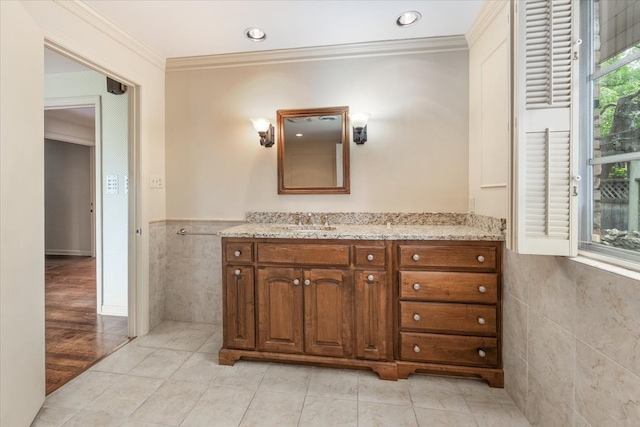 2900 Simondale Dr, Fort Worth, TX 76109 - bathroom with tile walls, ornamental molding, vanity, wainscoting, and tile patterned flooring