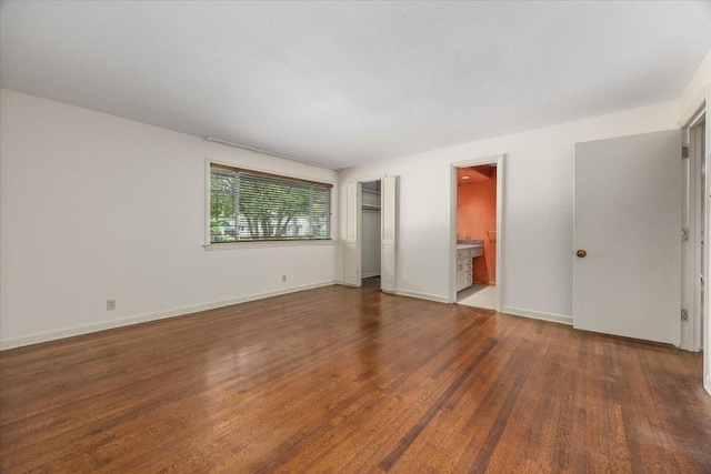 2900 Simondale Dr, Fort Worth, TX 76109 - unfurnished bedroom featuring wood finished floors, baseboards, and ensuite bathroom