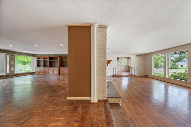 2900 Simondale Dr, Fort Worth, TX 76109 - spare room with healthy amount of natural light, ornate columns, baseboards, a textured ceiling, and recessed lighting
