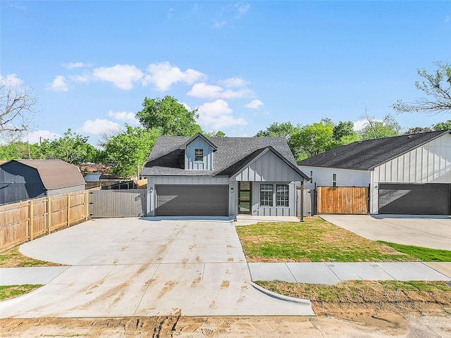 4405 Baylor St, Fort Worth, TX 76119 - modern farmhouse style home featuring a gate, fence, concrete driveway, board and batten siding, and a garage