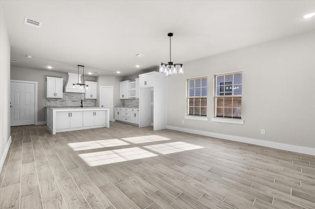 4405 Baylor St, Fort Worth, TX 76119 - kitchen with a chandelier, light wood-type flooring, baseboards, and recessed lighting