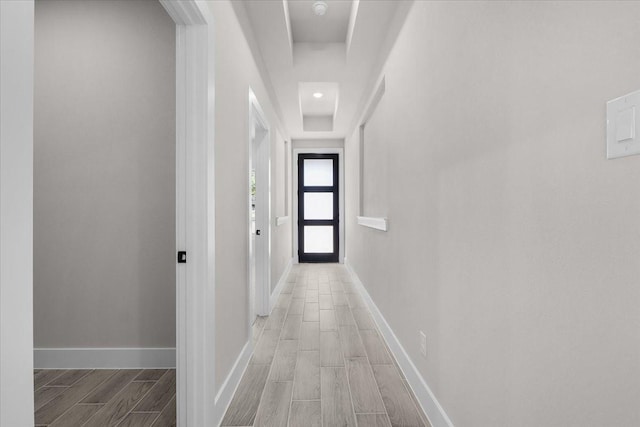 4405 Baylor St, Fort Worth, TX 76119 - hall featuring wood tiled floors, a tray ceiling, and baseboards