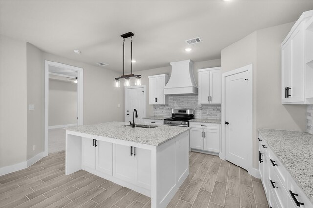 4405 Baylor St, Fort Worth, TX 76119 - kitchen featuring custom range hood, electric stove, a sink, wood tiled floors, and recessed lighting